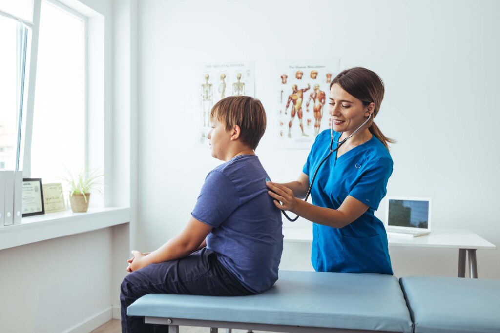Doctor listens to child's respiratory system using a stethoscope