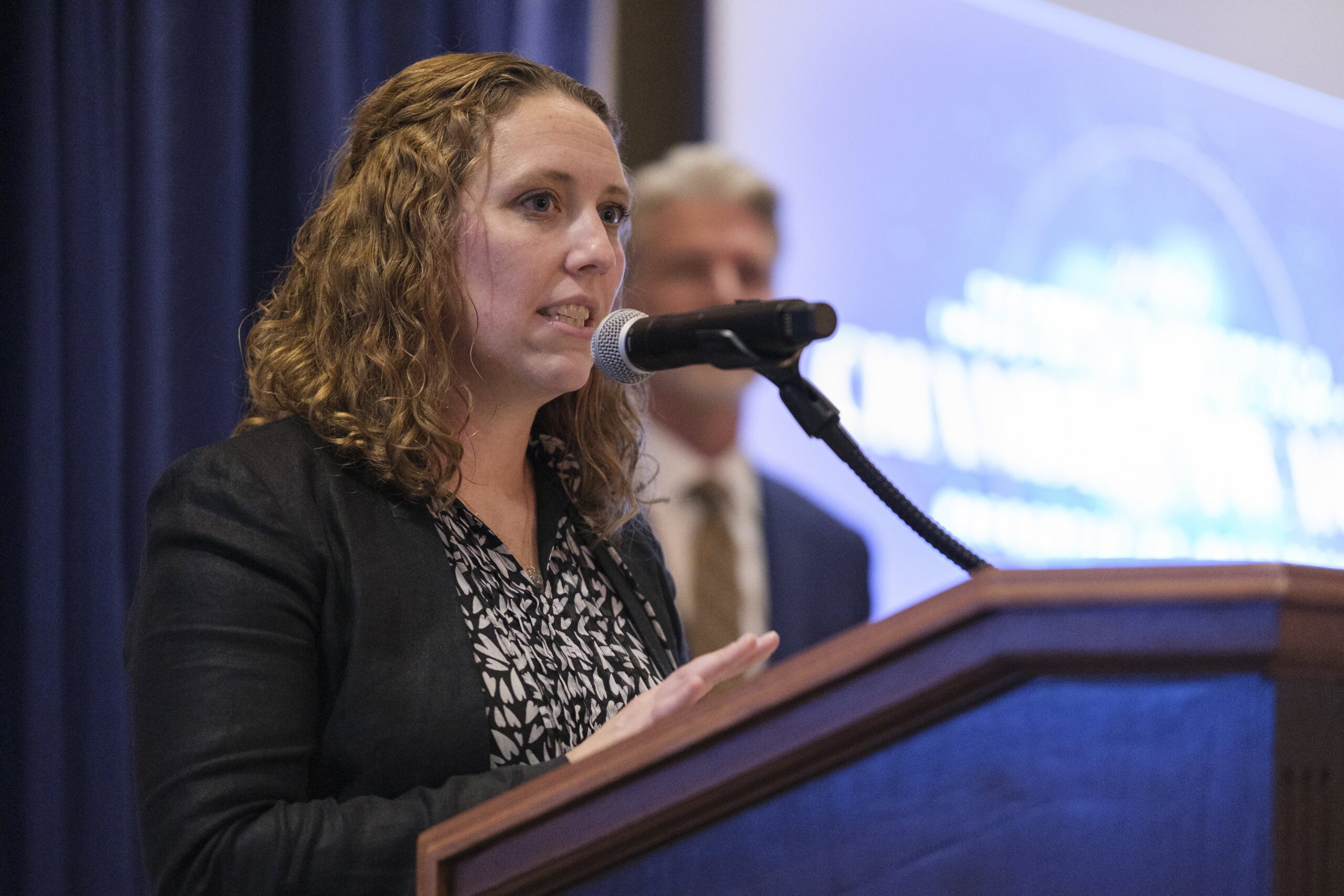 A person speaks at a podium.